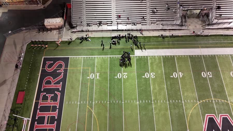 A football field under stadium lights