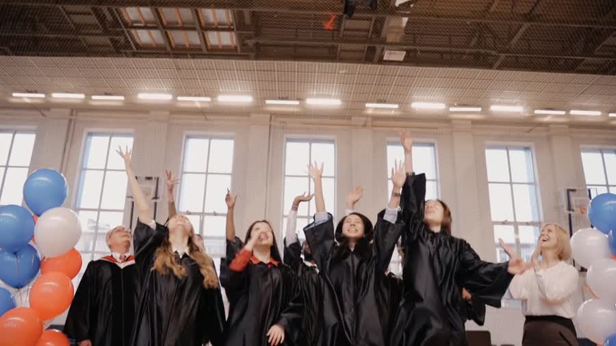 Graduates throwing their caps